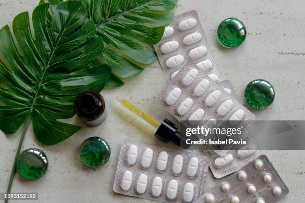 blister packs of pills and essential oils - folic acid stock pictures, royalty-free photos & images
