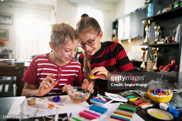 brother and sister making biological cell model of for school - preteen girl models stock pictures, royalty-free photos & images