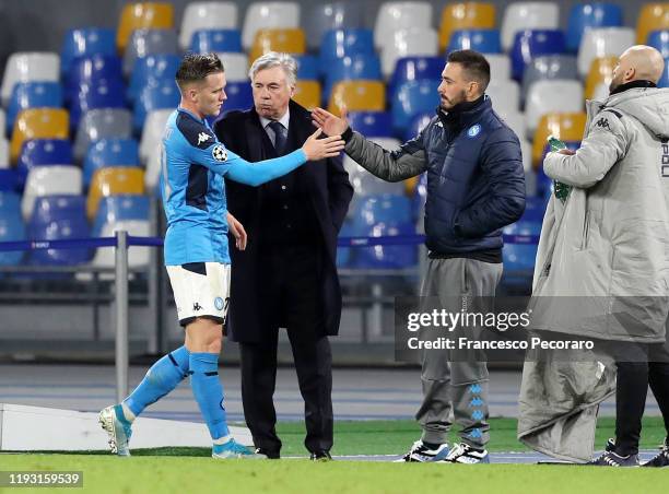 Piotr Zielinski of SSC Napoli greets Carlo Ancelotti SSC Napoli coach and his assistant Davide Ancelotti during the UEFA Champions League group E...