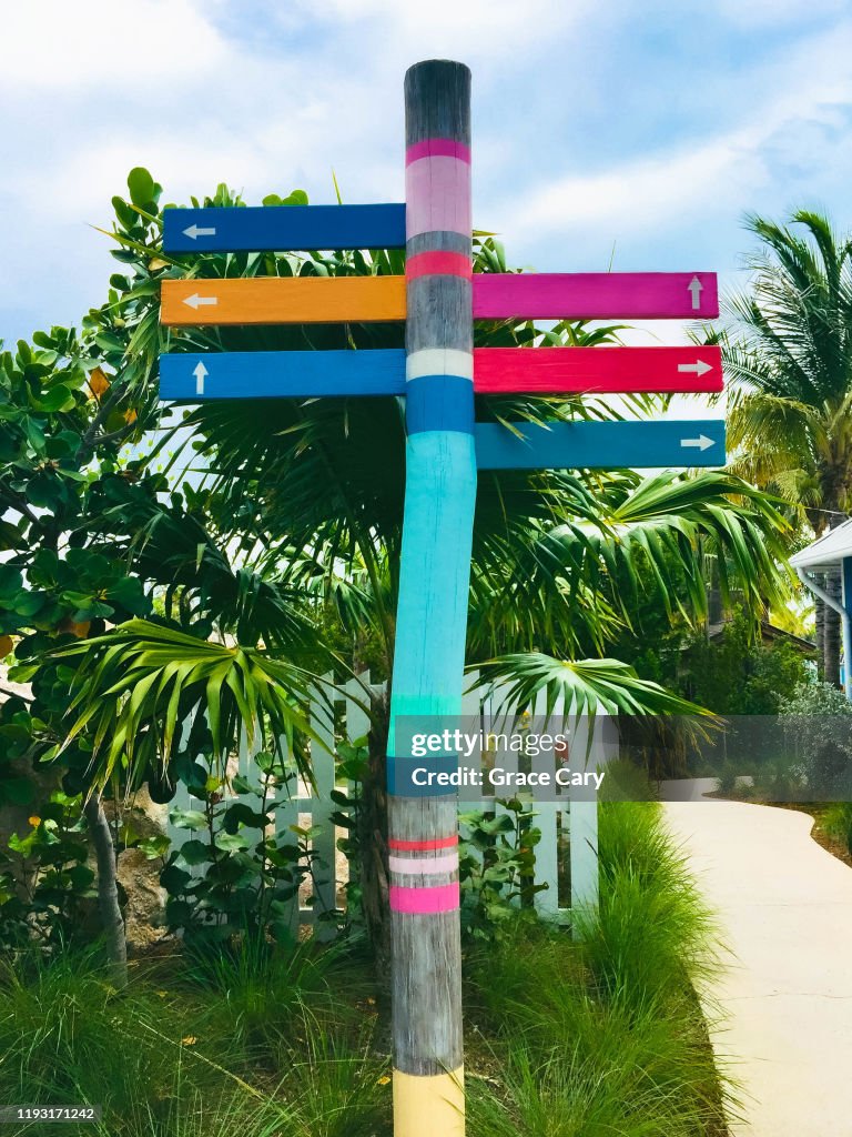 Painted Wooden Post with Directional Arrows