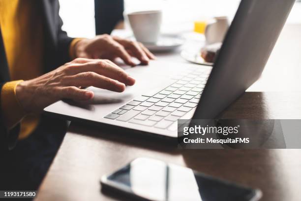 close up of hands using laptop - entering stock pictures, royalty-free photos & images