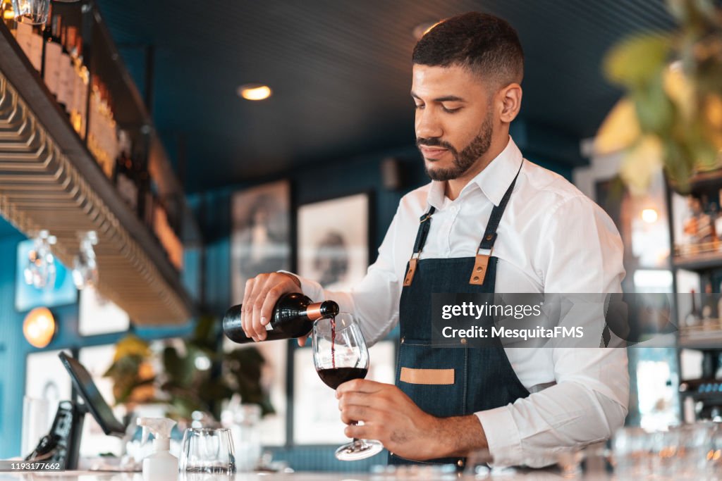 Sommelier pouring wine in the wineglass