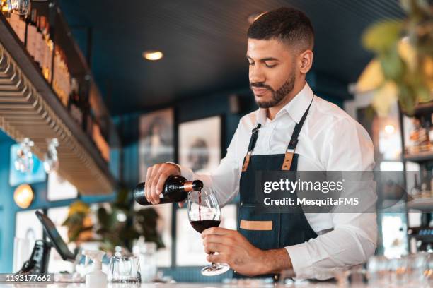 sommelier pouring wine in the wineglass - sommelier stock pictures, royalty-free photos & images