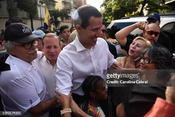 Opposition leader and reelected president of the National Assembly by anti-Maduro lawmakers majority Juan Guaido greets supporters as he arrives to a...