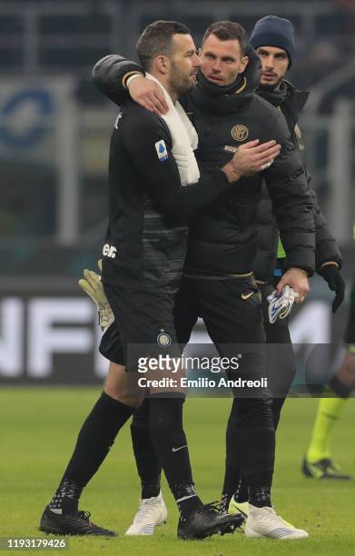 Daniele Padelli of FC Internazionale embraces his team-mate Samir Handanovic at the end of the Serie A match between FC Internazionale and Atalanta...