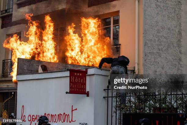 Advertising billboard is burning during a demonstration in Paris, on January 11 as part of a nationwide multi-sector strike against the French...