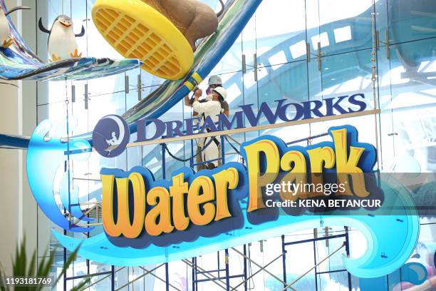 Workers clean the installation of the Dream Works Water park at the American Dream mall located in East Rutherford, New Jersey on December 19, 2019.