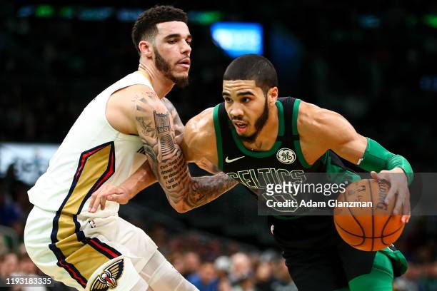 Jayson Tatum of the Boston Celtics drives to the basket past Lonzo Ball of the New Orleans Pelicans during a game at TD Garden on January 11, 2019 in...
