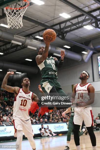 Shannon Bogues of the Wisconsin Herd shoots against Sheldon Mac and Malik Newman of the Canton Charge of the Canton Charge during an NBA G-League...