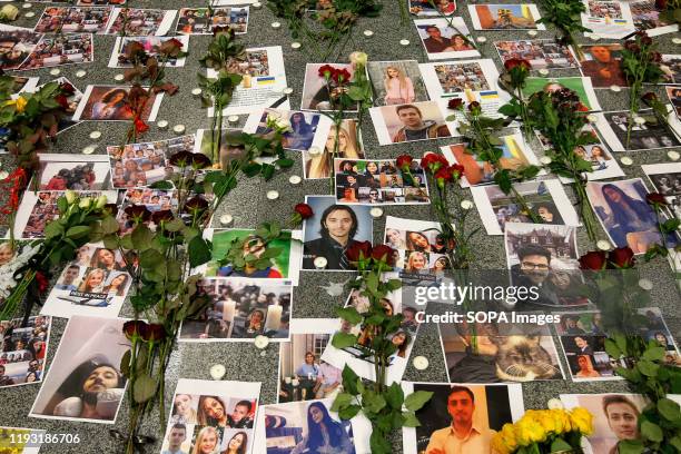 Flowers seen placed on the portraits of the victims of flight PS 752 at the memorial corner of Boryspil International Airport. Ukrainian...