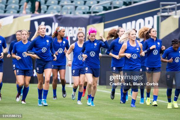 Megan Rapinoe of United States with pink hair gives a thumbs up to fans as she leads the members of the United States Women's National team and the...