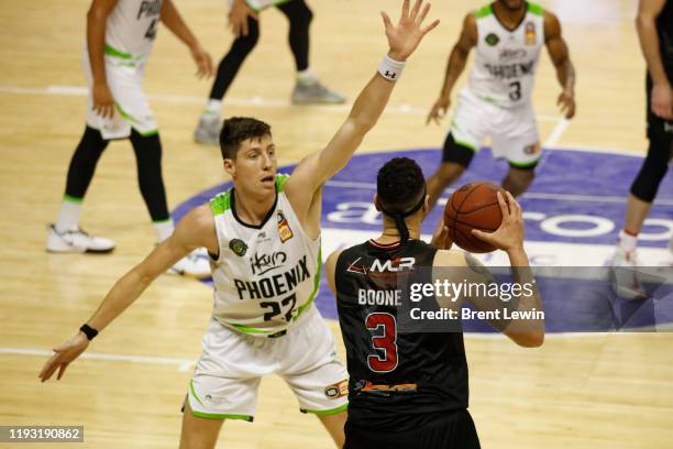 Dane Pineau of the Phoenix, left, guards Josh Boone of the Hawks during the round 15 NBL match between the Illawarra Hawks and the South East...