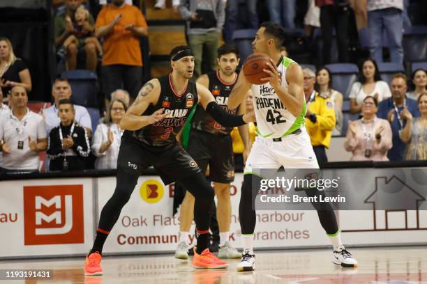 Josh Boone of the Hawks, left, guards Tai Wesley of the Phoenix during the round 15 NBL match between the Illawarra Hawks and the South East...