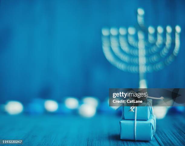 defocused hanukkah background with menorah, gifts and dreidel - hanukkah stock pictures, royalty-free photos & images