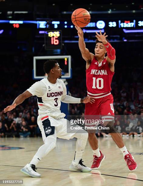 Rob Phinisee of the Indiana Hoosiers makes a pass past Alterique Gilbert of the Connecticut Huskies during the second half of their game at Madison...