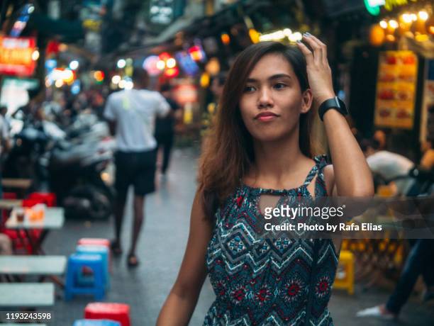 young woman out in old town street - hanoi bar stock pictures, royalty-free photos & images