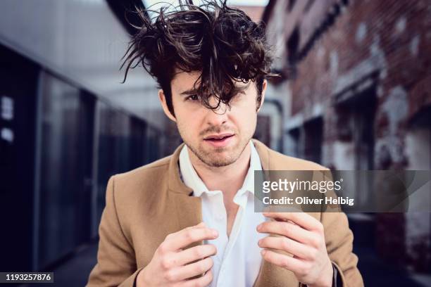 young men with tangled hair - tousled hair man stock pictures, royalty-free photos & images