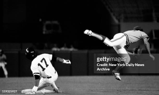 Baseball Yankees vs Oakland - Yankees' Oscar Gamble slides into second base as Dave McKay of A's chases bad throw on ball hit by Reggie Jackson.