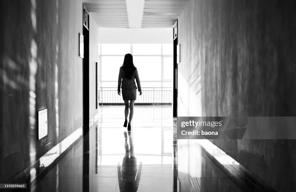 Businesswoman through the office corridor