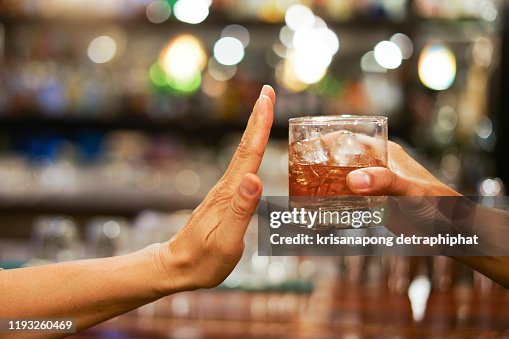 Stop drinking,Stop drinking conceptMan alcoholic social problems sitting at table refusal of alcohol say no to addiction close-up Stop drinking,Stop drinking conceptMan alcoholic social problems sitting at table refusal of alcohol say no to addiction close-up
