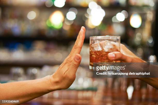 stop drinking,stop drinking conceptman alcoholic social problems sitting at table refusal of alcohol say no to addiction close-up - drunk woman 個照片及圖片檔