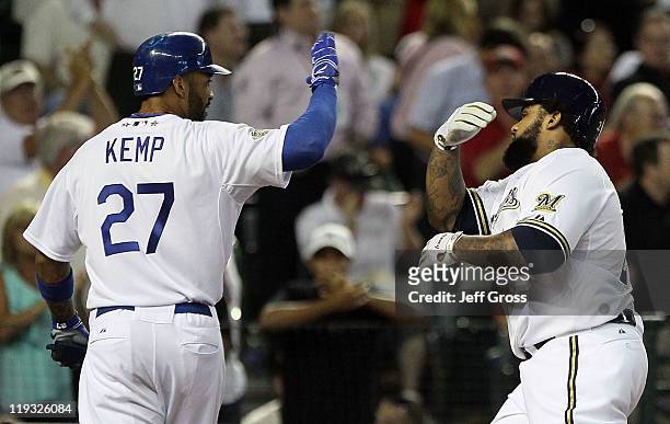 National League All-Star Prince Fielder of the Milwaukee Brewers hits a three-run home run in the fourth inning and celebrates with teammate Matt...