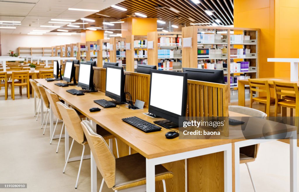 One Computer At Library Computers And Bookshelves In Modern Library High-Res Stock Photo ...