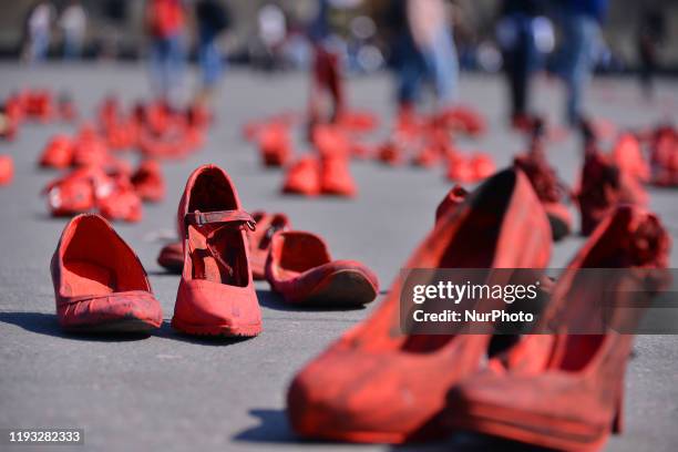 Group of women join at Zocalo to take part during a protest with red-painted shoes to celebrate 30 years of feminicide in Mexico and demand justice...