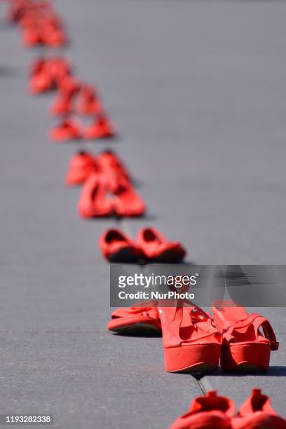 Group of women join at Zocalo to take part during a protest with red-painted shoes to celebrate 30 years of feminicide in Mexico and demand justice...