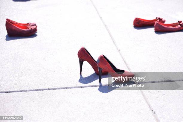 Group of women join at Zocalo to take part during a protest with red-painted shoes to celebrate 30 years of feminicide in Mexico and demand justice...