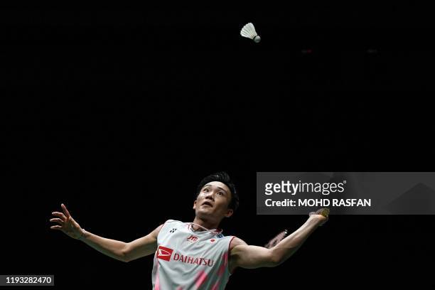 Japan's Kento Momota eyes a return against Denmark's Viktor Axelsen during their men's singles final match at the Malaysia Open badminton tournament...