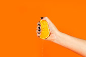 Woman crushing a half orange