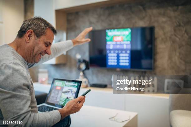 mature man wins the online bet - football net stock pictures, royalty-free photos & images