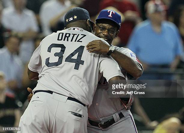 American League All-Star David Ortiz of the Boston Red Sox hugs American League All-Star manager Ron Washington of the Texas Rangers before the start...