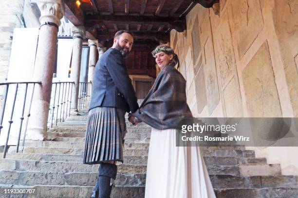 newly wed couple on open medieval staircase - kult stock pictures, royalty-free photos & images