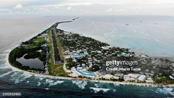 An aerial view of downtown and the airport runway, between the Pacific Ocean and lagoon , on November 28, 2019 in Funafuti, Tuvalu....