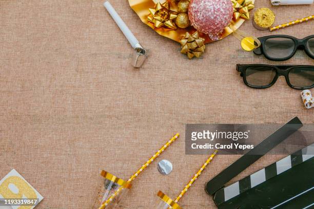 movie tickets, clapperboard, pop corn and 3d glasses in golden background.new years - golden reel stock pictures, royalty-free photos & images