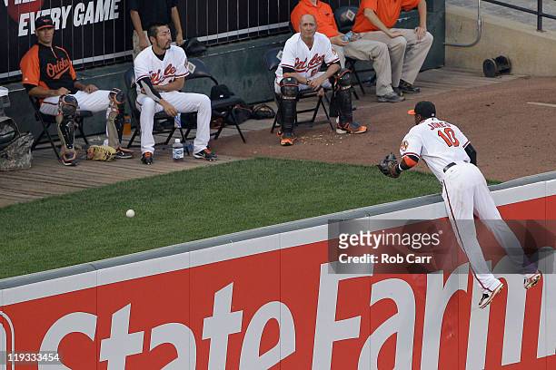 Center fielder Adam Jones of the Baltimore Orioles hangs from wall and watches the home run ball of Jarrod Saltalamacchia of the Boston Red Sox , go...