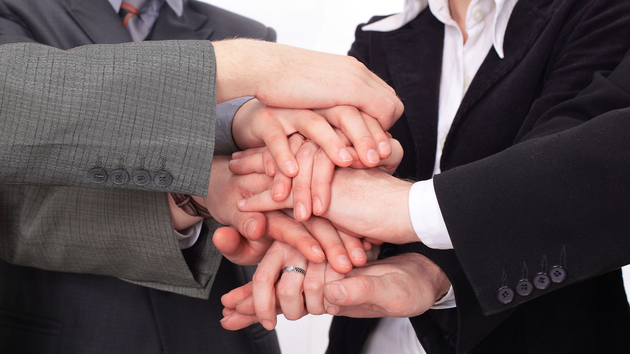 group of business people with hands clasped together. group of business people with hands clasped together.