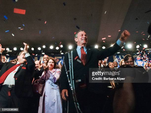 As ticker tape falls, American politician New York City Mayor Michael Bloomberg and his supporters celebrate winning a second term during an election...