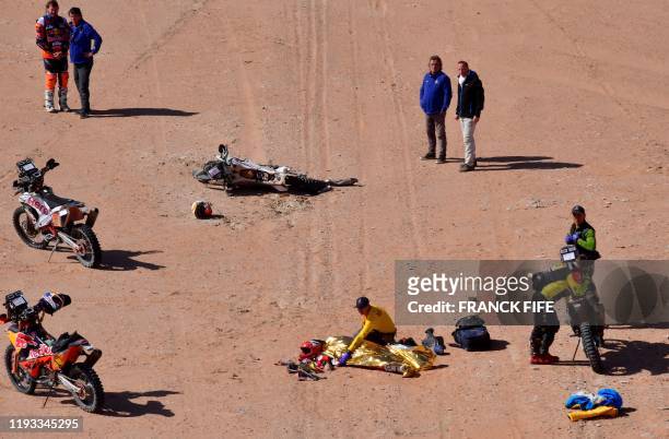 Hero's Portuguese motorbike rider Paulo Goncalves is attended by medical staff after a crash during the Stage 7 of the Dakar 2020 between Riyadh and...