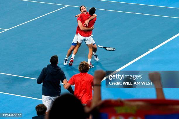 Viktor Troicki and Novak Djokovic celebrate after Serbia defeated Spain in the final of the ATP Cup tennis tournament in Sydney on January 13, 2020....