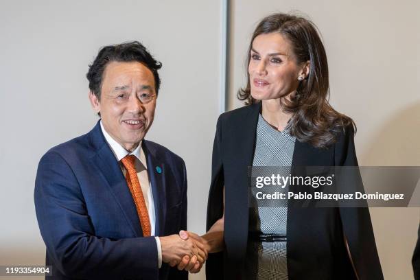 Queen Letizia of Spain and Director-General of the Food and Agriculture Organization of the United Nations Qu Dongyu shake hands during an event at...