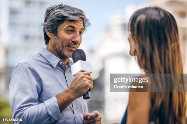 woman answering to journalists on the street - television interview stock pictures, royalty-free photos & images