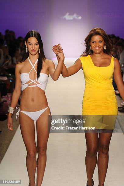 Designer Veronique De La Cruz walks the runway with a model at the Aquarella Swimwear show during Merecedes-Benz Fashion Week Swim 2012 on July 18,...