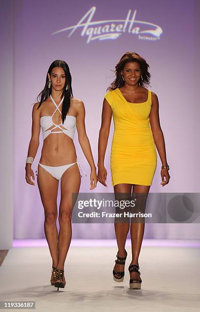 Designer Veronique De La Cruz walks the runway with a model at the Aquarella Swimwear show during Merecedes-Benz Fashion Week Swim 2012 on July 18,...