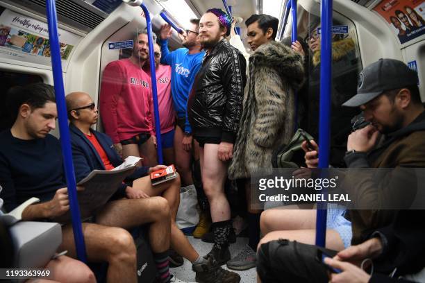 People take part in the annual 'No Trousers On The Tube Day' on the London Underground in central London on January 12, 2020. - Starting in 2002 with...