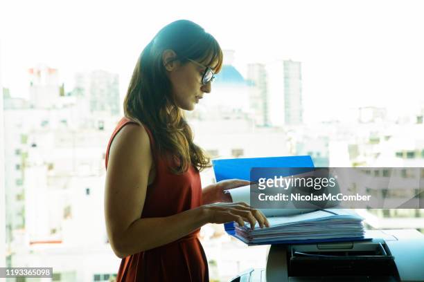 mid adult professional woman preparing to copy large document - large printer stock pictures, royalty-free photos & images