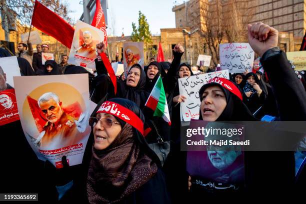 Protesters chant slogans while holding up posters of Gen. Qassem Soleimani during a demonstration in front of the British Embassy on January 12, 2020...