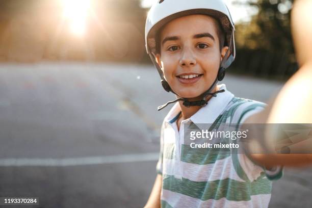 boy with cycling helmet taking selfie outside - teenager cycling helmet stock pictures, royalty-free photos & images